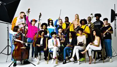 A diverse group of creative talents, including actors, musicians, and models, collaborating in a vibrant studio setting.
